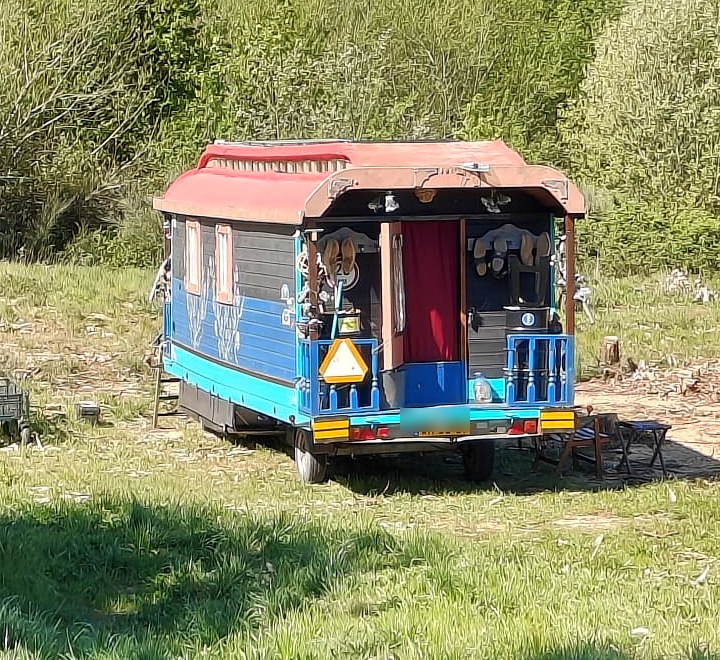 The real hand-painted caravan parked in the Portuguese countryside